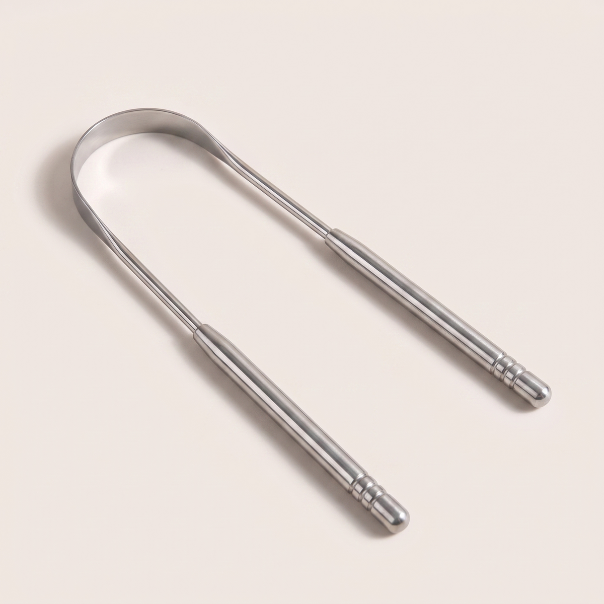 A stainless steel U-shaped tongue scraper