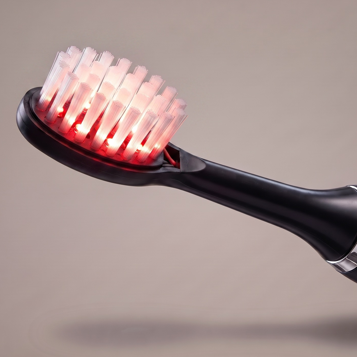 Close-up of a lit Solstra brush head mounted on the handle