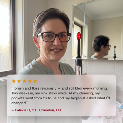 A smiling woman in glasses holds the Solstra toothbrush, its head glowing red, above a five-star review: "I brush and floss religiously — and still bled every morning. Two weeks in, my sink stays white. At my cleaning, my pockets went from 5s to 3s and my hygienist asked what I'd changed." — Patricia D., 51 · Columbus, OH